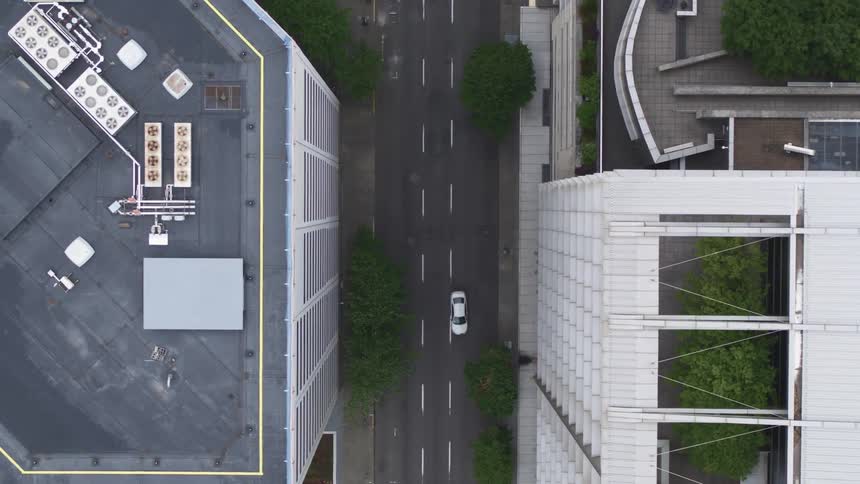 A vehicle drives on the road in the city