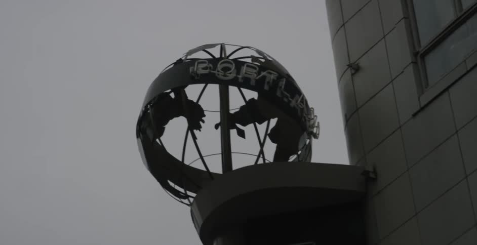 A round structure is displayed on the edge of a building