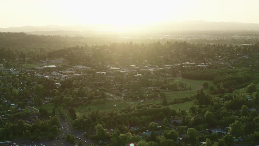 Aerial view of a small town in the hills at sunset