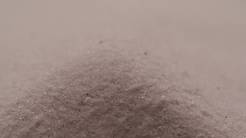 Sand on a beach blows back and to the side