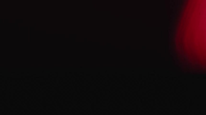 Strobing red light at the edge against a black dark background