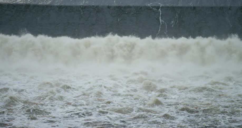 Water churns and gushes over a small waterfall