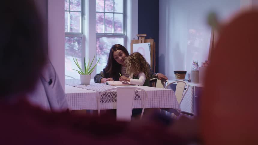 Parents watch as a young girl is tutored