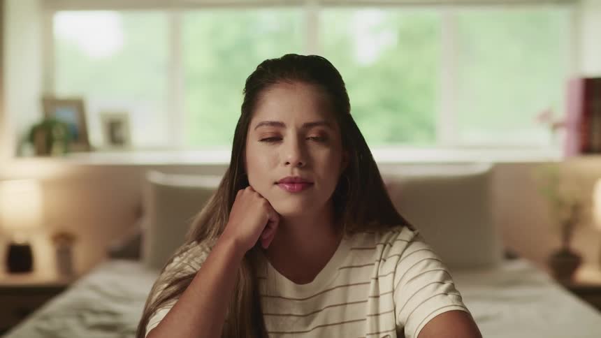 A woman is nodding in her bedroom