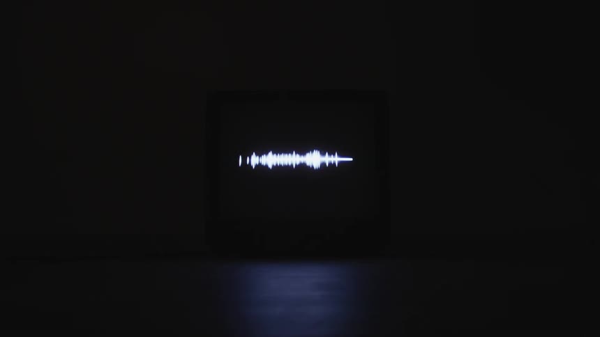 A white equalizer light flashes in varying strengths against a black wall