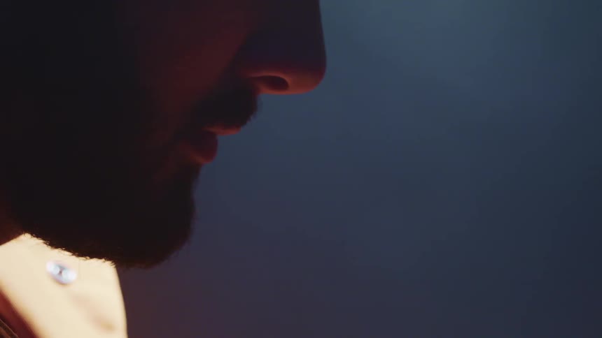 Man remains still as background shadows brighten and darken