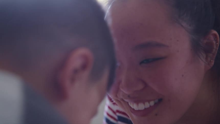 Mother and son lay on the floor laughing and smiling
