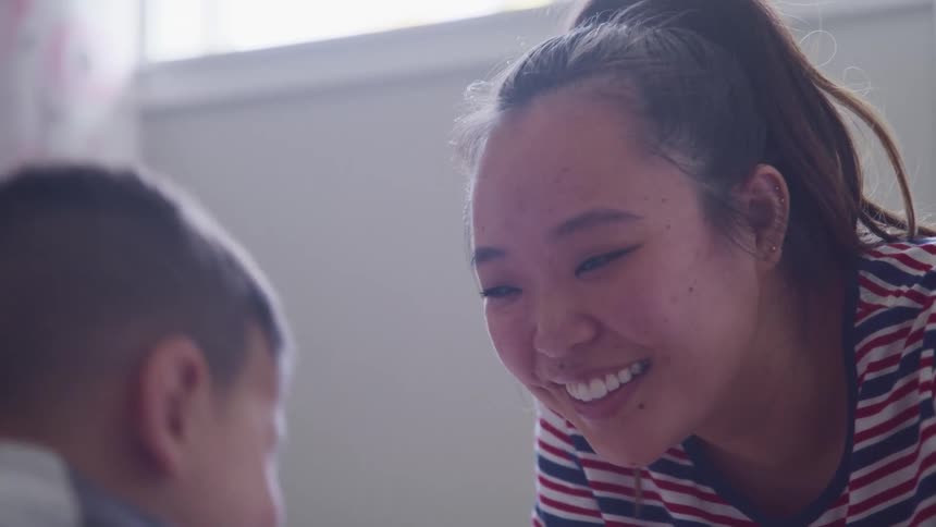 A mother and son laugh together
