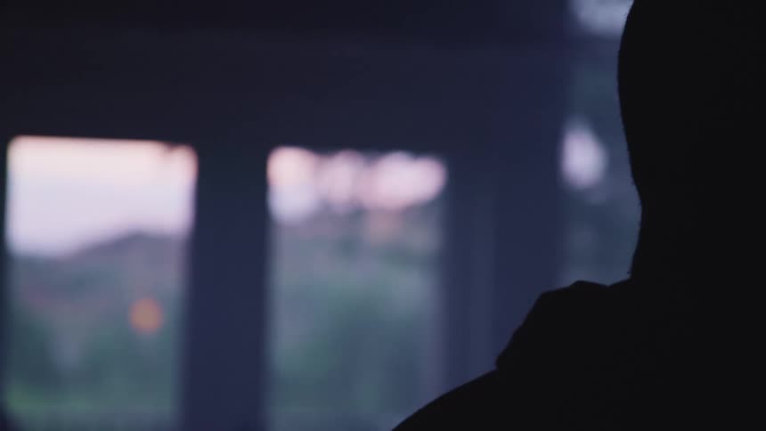 A person is in a dark room covered in darkness