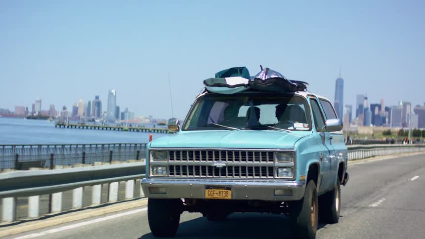 People are driving in a car near the oceanside