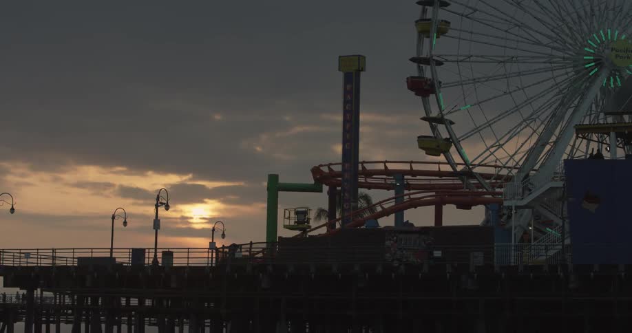 Amusement park on a pier at sunset