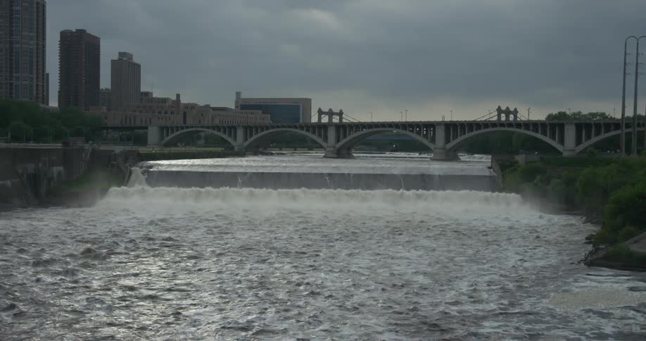 A dam is moving water along a canal on a cloudy day
