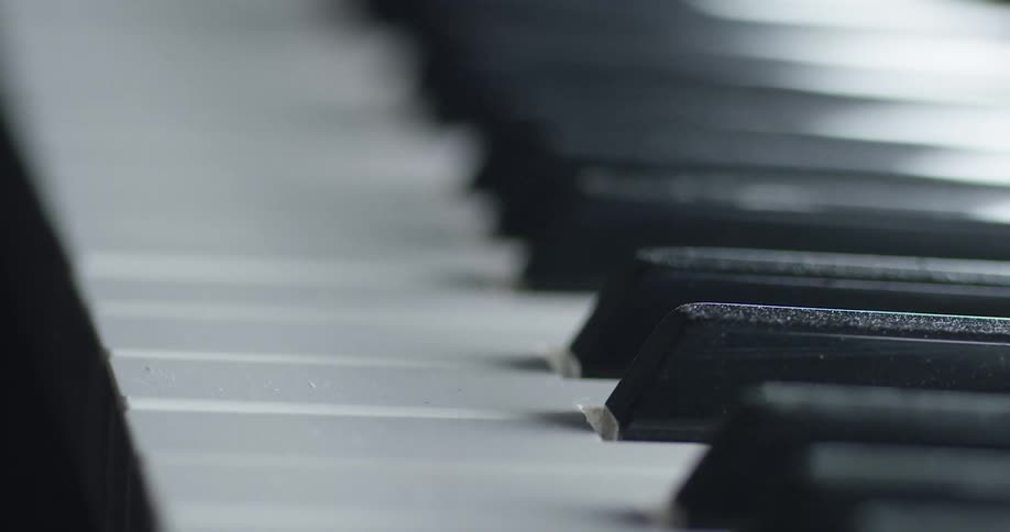 The keys of the piano sit undisturbed