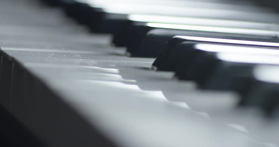 The keys on a piano are reflecting light