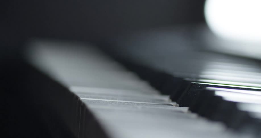 Light reflects off piano keys