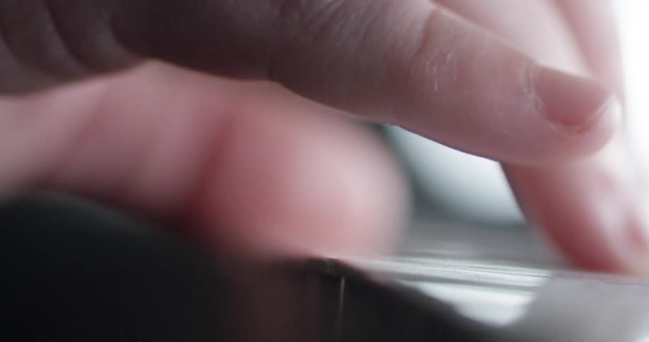 Fingers press piano keys