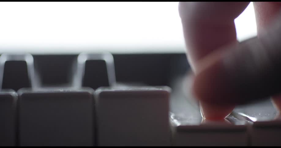 A person is pressing the keys on a piano