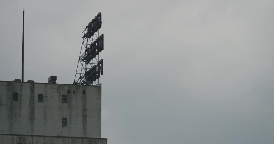 Building with signage rising above it on a cloudy day