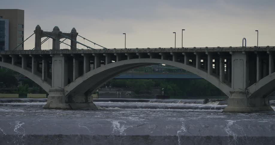 Water flows beneath a city bridge