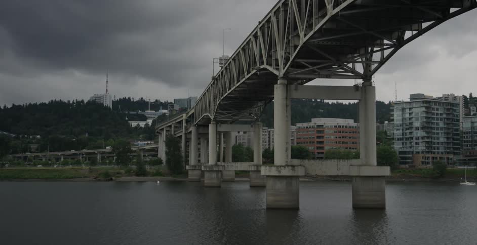 A bridge leads to a town on a cloudy day