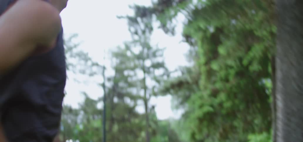 Man with a running top jogs in a public park