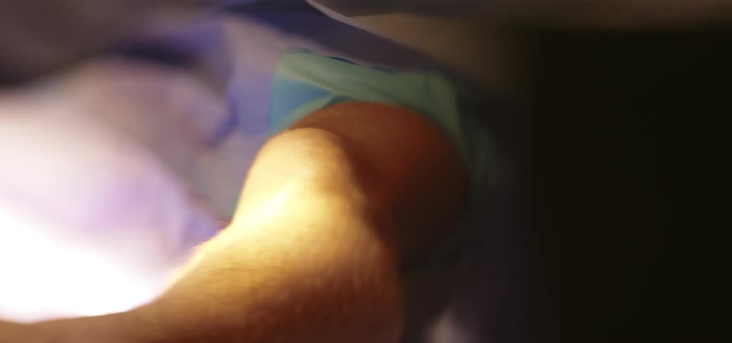 Close up of the leg of a patient laying on an operating table