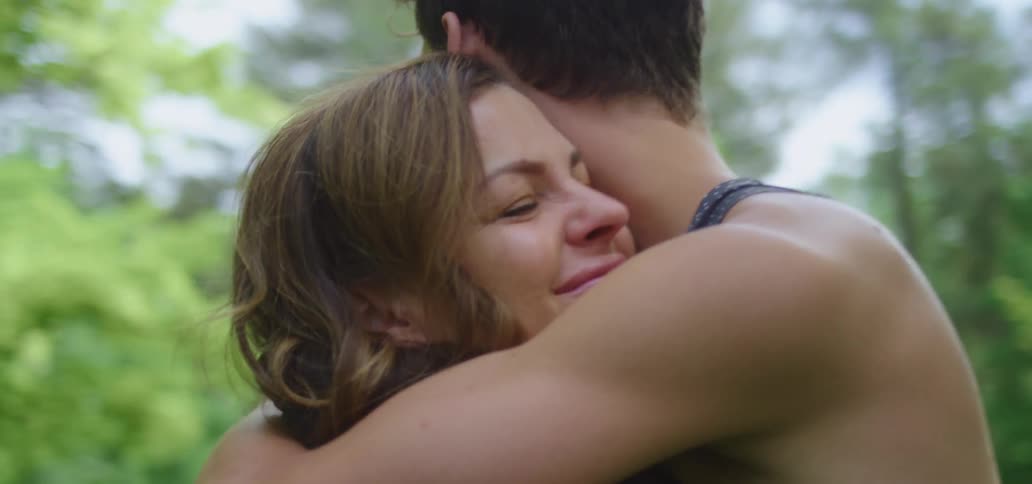 A man and woman are hugging outdoors