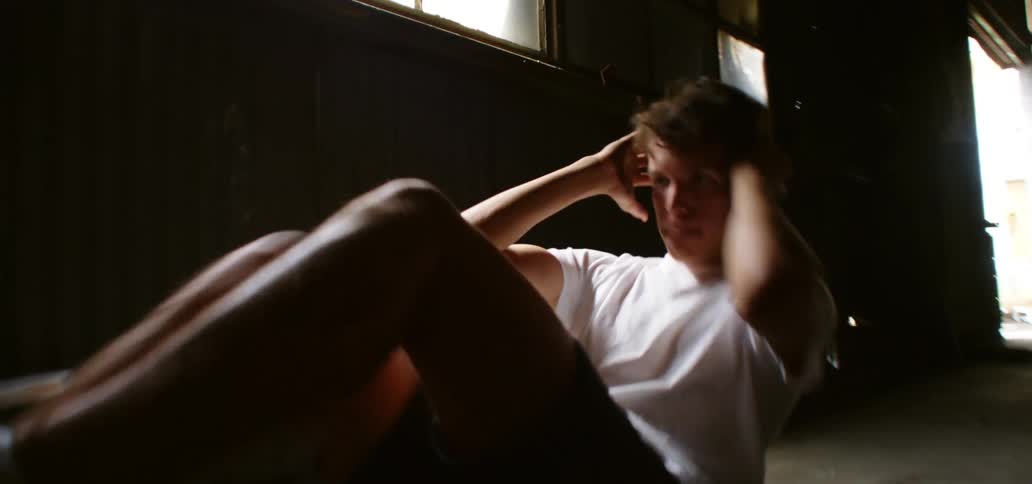 A teenager exercising indoors