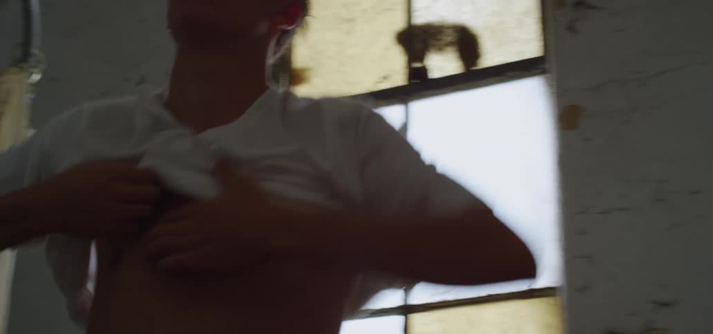 Man wears a white t shirt in the bathroom