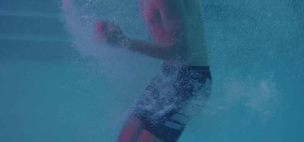 A man is running in place in the pool