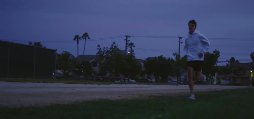A man is jogging outdoors at night