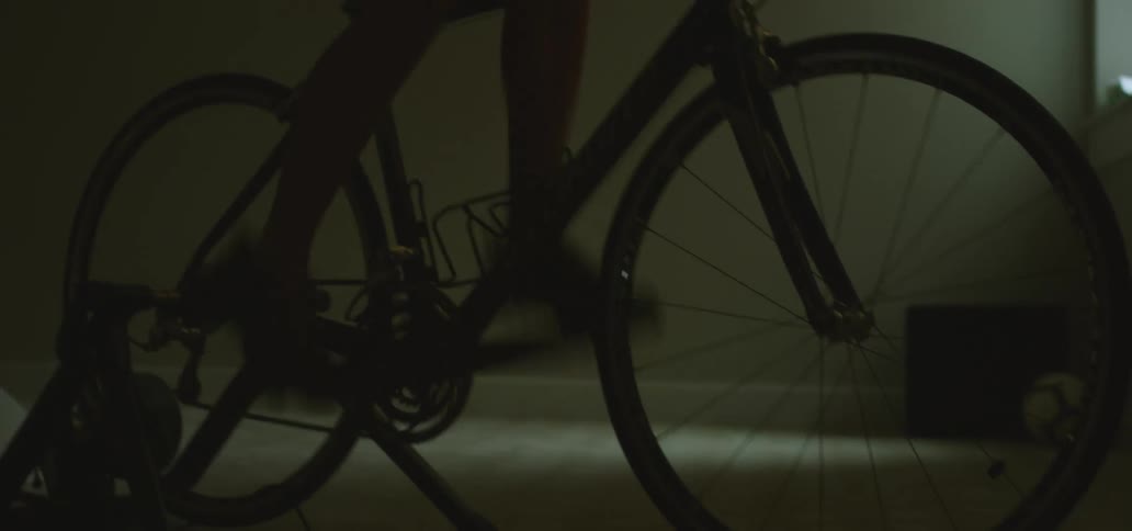 A man is exercising on a bike indoors