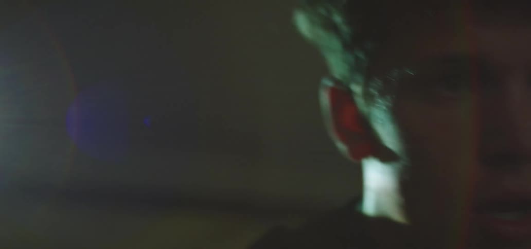 A young male dancing fast and sweating in a room with bright lighting