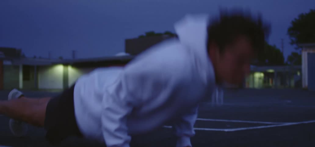 A man is exercising outdoors at night