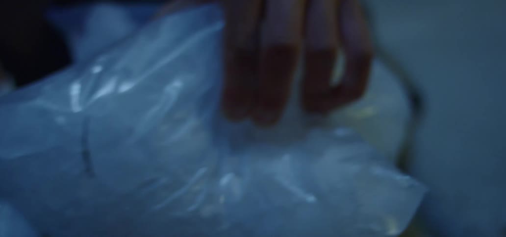 A person puts ice on his knee