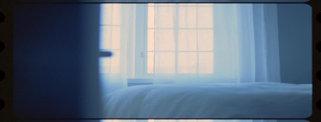 White curtains and comforter in a bedroom