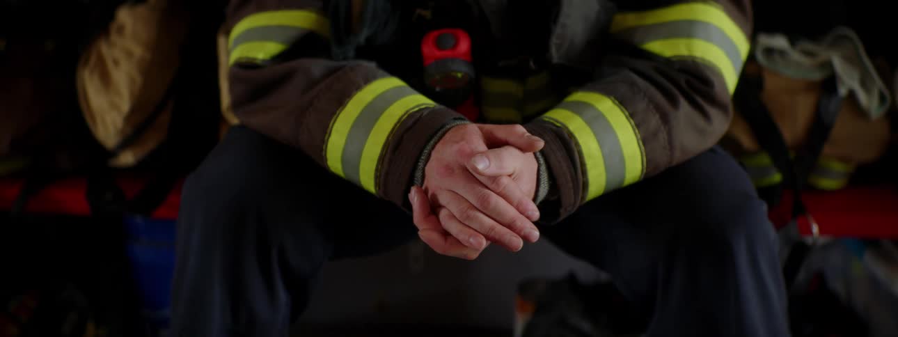 A firefighter is sitting in the fire house