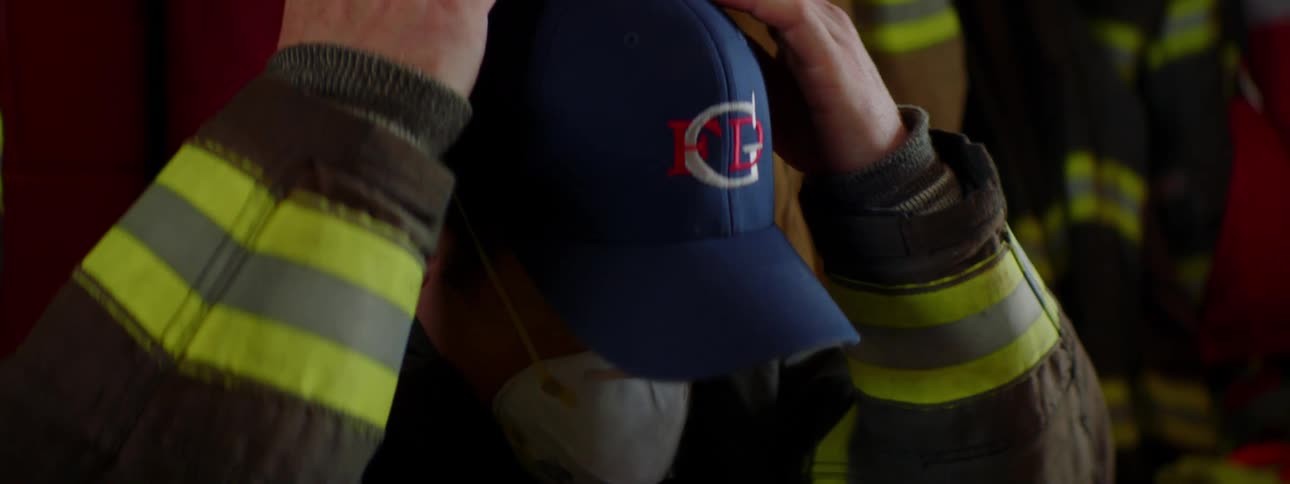 A fireman places a medical mask over his face