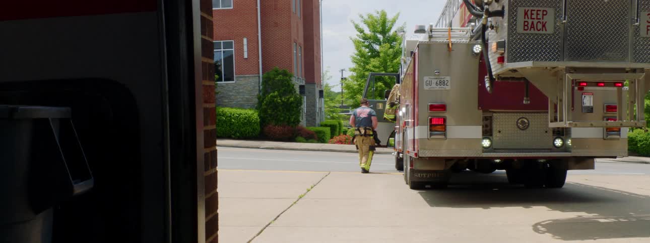 A firefighter walks towards the truck