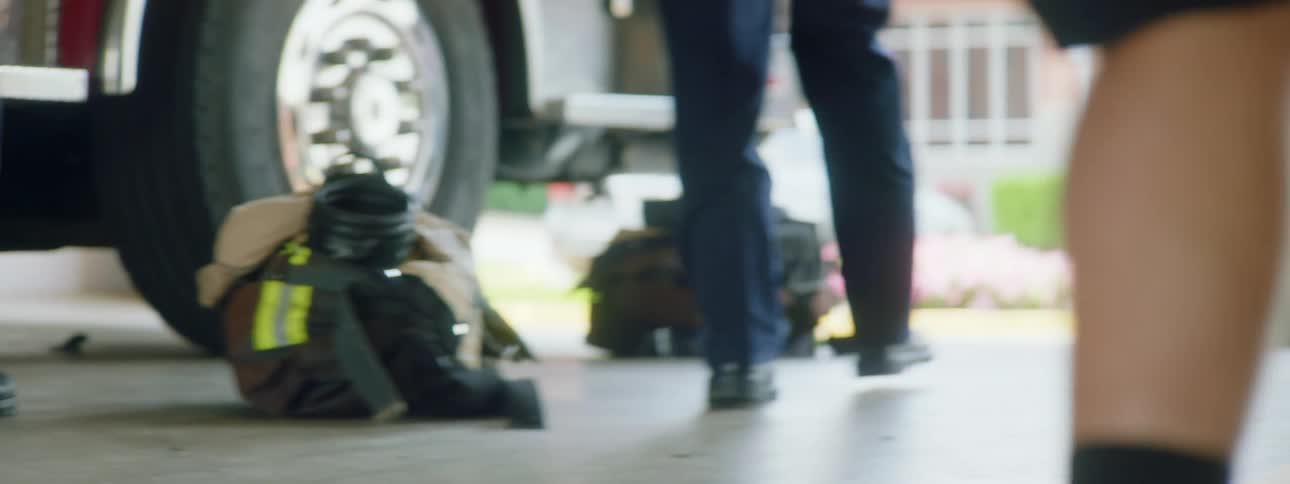 Firefighters walk over to the truck to gear up