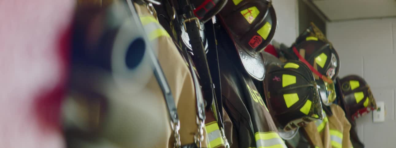 Firefighter equipment hanging on the wall of a fire station