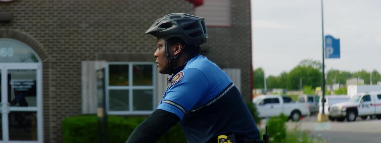A police officer is riding a bicycle