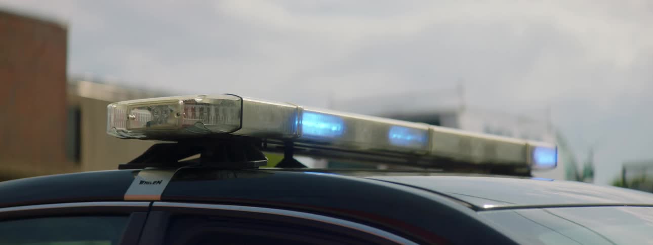 Blue strobing lights on the roof of a police car
