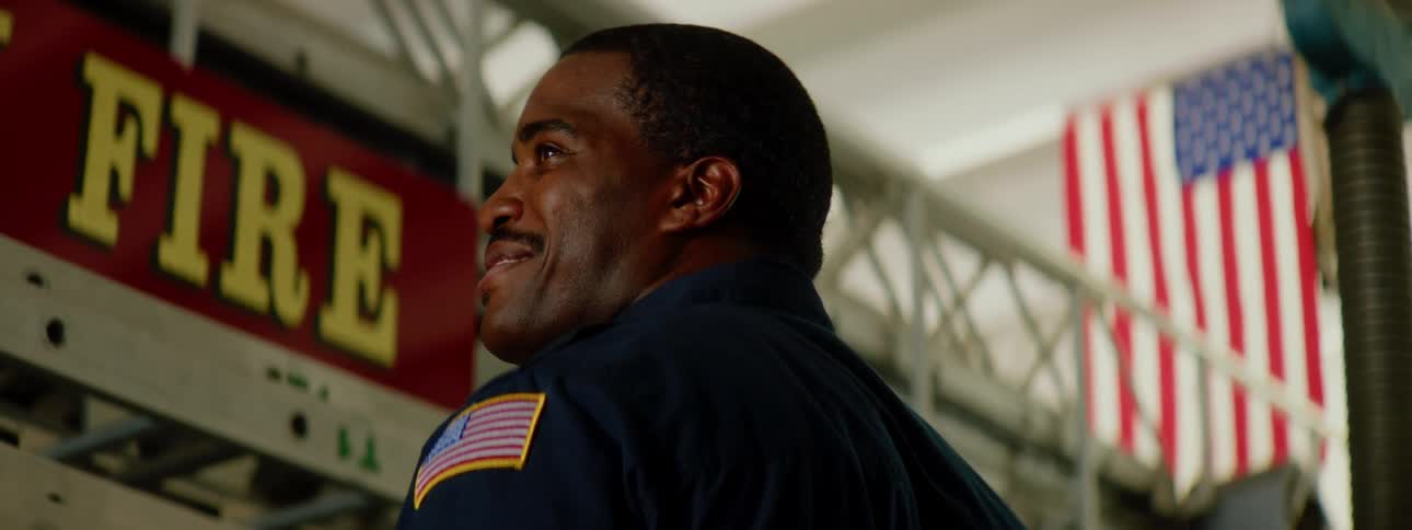 A firefighter smiles in the fire house