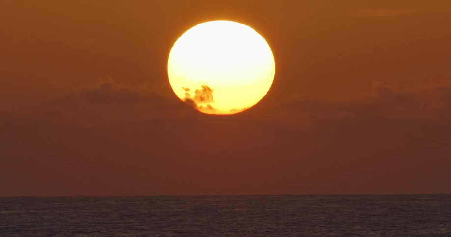 A view of the ocean is displayed at dusk