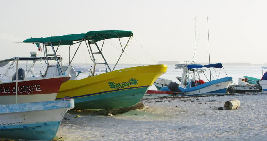 Colorful boats are anchored on a sandy beach
