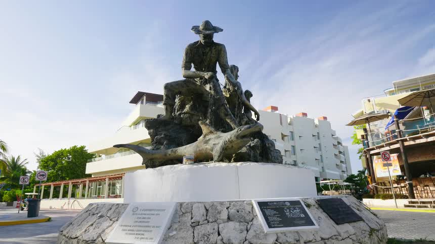 A large statue sits near the city