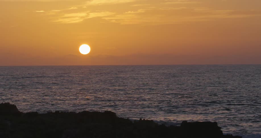 The low sun over the ocean at sunset