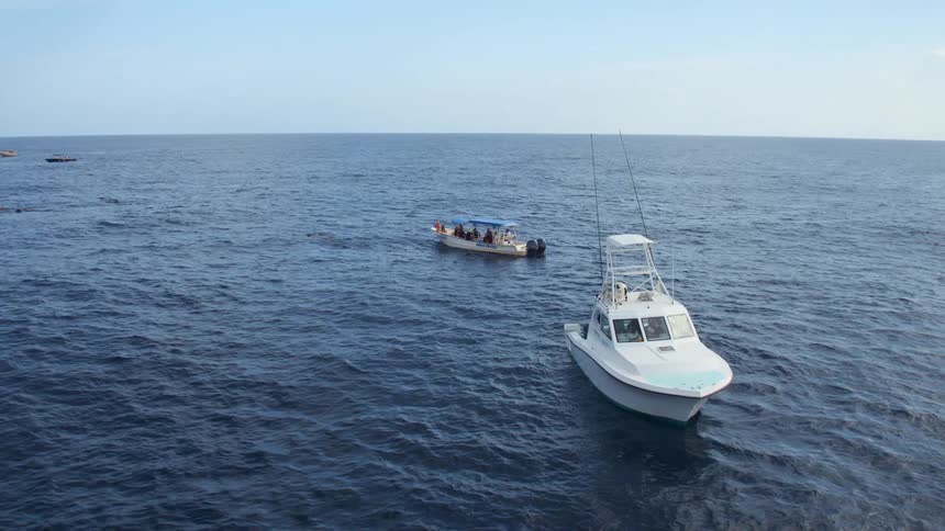 People relaxing on boats in the ocean