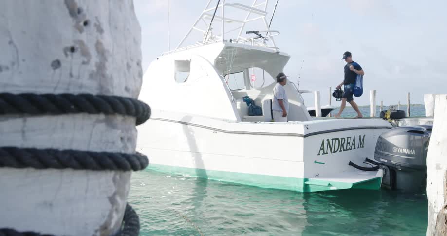 A man loads his belongings onto the boat